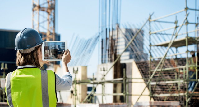 lady on construction site with ipad